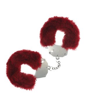 A pair of metal handcuffs with red faux fur lining on a white background.