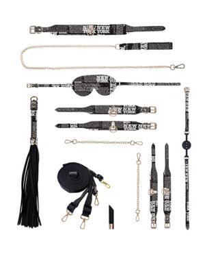 Assorted fashion accessories with black and white New York print, including straps, belts, and a tassel.