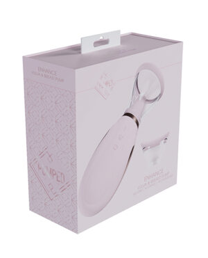 A breast pump device and its packaging. The packaging reads "ENHANCE VULVA & BREAST PUMP" and features a window through which the device is visible. The device has a modern design with a white and metallic color scheme.
