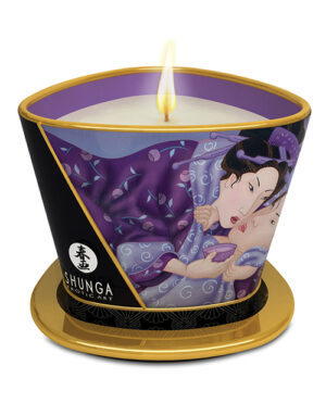 Shunga Art Candle::A beautifully designed candle featuring an artistic depiction of intimate figures, set in a decorative container with a golden base and a gentle flame illuminating the top.