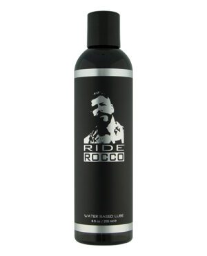A bottle of Ride Rocco water-based lube, 8.5 oz / 255 ml, with a silhouette of a man's face and upper body in the label design.