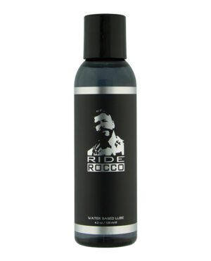 A black bottle with a label featuring the silhouette of a man's face and the words "RIDE ROCCO WATER BASED LUBE 4.2 oz / 125 ml" on a white background.