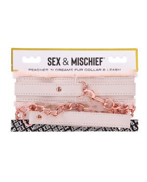 A pink fur collar and leash set with rose gold chains and white straps, packaged and labeled 'SEX & MISCHIEF Peaches 'n Creame Fur Collar & Leash'.