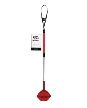 Kiss Crop Paddle::A red kiss-shaped crop paddle with a black handle, designed for playful impact, accompanied by its packaging labeled "SEX & MISCHIEF".