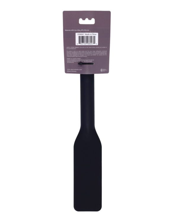 A black silicone spatula displayed with its label showing materials and barcode, set against a white background.