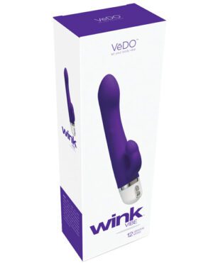 A product packaging for a VeDo Wink Vibe adult toy, predominantly white with purple accents, featuring an image of the product on the front.
