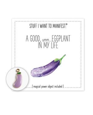 An illustration of a wish card titled 'STUFF I WANT TO MANIFEST' featuring text 'A GOOD, umm... EGGPLANT IN MY LIFE' with an image of a decorated eggplant and a matching eggplant-shaped charm.