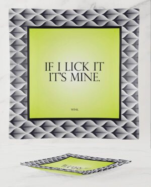 A framed poster on a marble surface with the text "IF I LICK IT IT'S MINE." written on a lime green background, surrounded by a black and white rope-like pattern border.