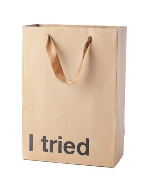 A brown paper shopping bag with the phrase "I tried" printed on it.