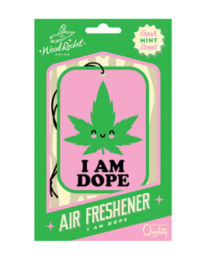 A packaged air freshener with a cartoon cannabis leaf and the words "I AM DOPE" on the front. The brand at the top is "WoodRocket," and there is a label indicating a fresh mint scent. The product is labeled as "Premium Quality."