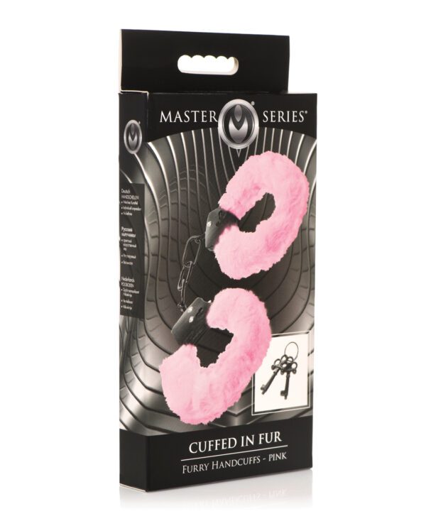 A pair of pink furry handcuffs displayed in a black product package labeled "Master Series" and "Cuffed in Fur".