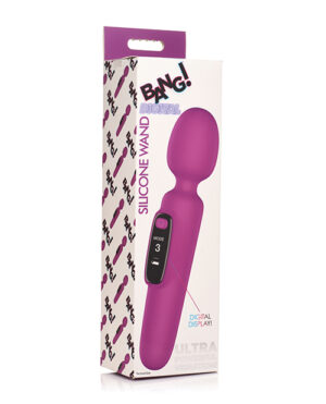 A purple silicone wand massager with a digital display, resting against its product packaging which is decorated with lightning bolts and text.