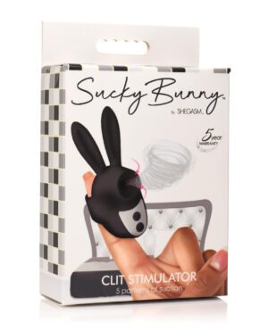 A hand holding a box of 'Sucky Bunny Clit Stimulator' by SHEGASM with a 5-year warranty claim on the packaging.