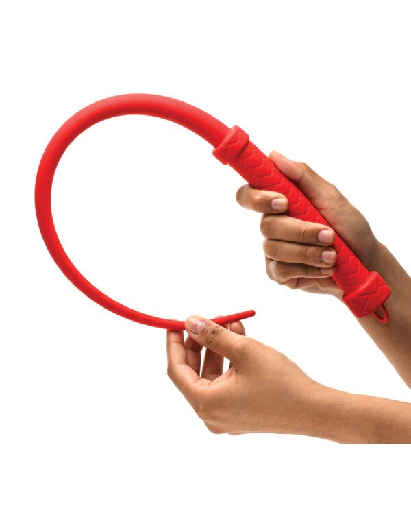 Two hands bending a flexible red tube against a white background